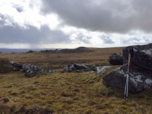 moorland with 2 walking poles propped against a stone