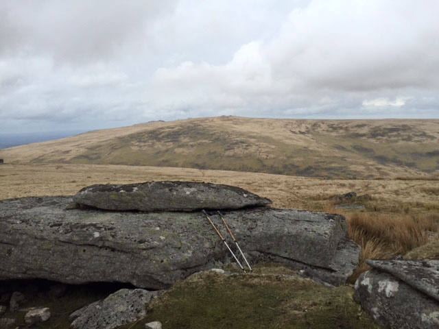 moorland with rocks and walking poles in foreground