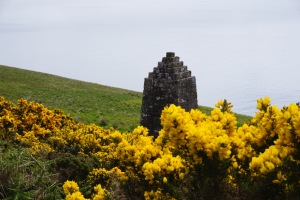 stone monument with gorse in foreground